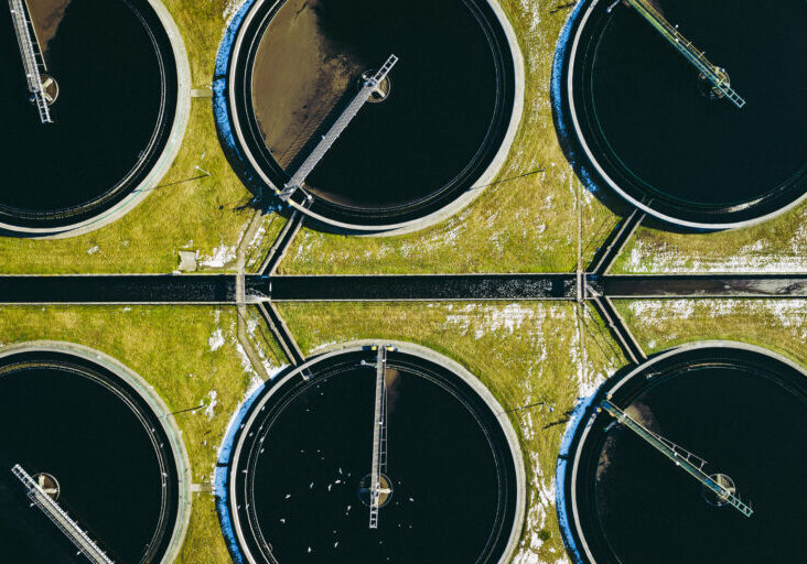 Sewage farm. Static aerial photo looking down onto the clarifying tanks. Industrial place. Geometric background texture. Photo captured with drone.